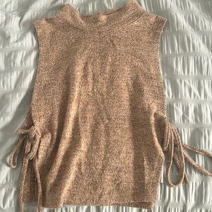 Brown top: the sides are slit open w/ strings to tighten the shirt on the sides